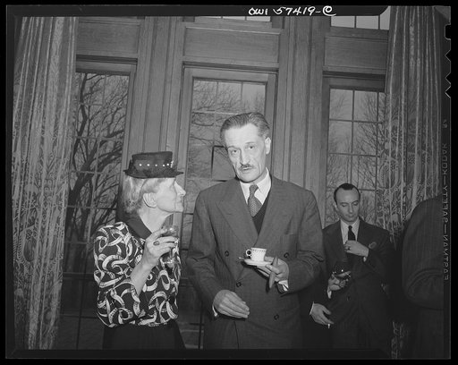 French journalists visiting the United States call on Ambassador Henri Bonnet, French Ambassador to the United States at the French Embassy where a luncheon was given for them. Ambassador Bonnet and Mme. Andree Viollis chat after the luncheon