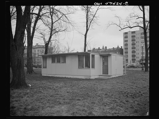Houses for Britain. Model of prefabricated house erected at Scott Circle, Washington, D.C. of the type of temporary, emergency dwelling which it is planned to ship to Great Britain under lend-lease. View of front of screen. Bathroom and one of two bedrooms behind kitchen