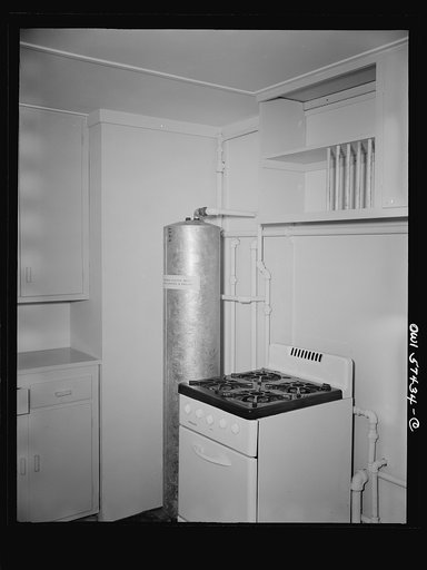 Houses for Britain. Detail of corner of kitchen in prefabricated, temporary, emergency house of the type which it is planned to ship to Great Britain under lend-lease. Submerged electric water heater will be supplied in England. Heater connects with space heater in living room