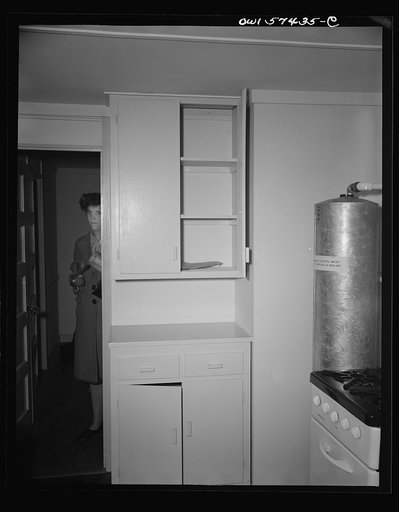 Houses for Britain. Detail of cupboards in corner of kitchen in prefabricated, temporary, emergency house of the type which it is planned to ship to Great Britain under lend-lease. This house was erected by the Federal Public Housing Authority at Scott Circle, Washington, D.C. Note submerged electri