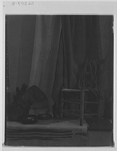 Rural arts exhibition held under the auspices of the Farm Security Administration (FSA) in the patio of the U.S. Department of Agriculture building. Chair with untanned hide seat, Extension Service, College Station, Texas; black pottery, Pueblo Indian Service (Marie pottery), San Ildefonso, New Mexi