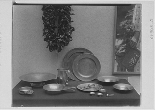 Rural arts exhibition held under the auspices of the Farm Security Administration (FSA) in the patio of the U.S. Department of Agriculture building. Spun and hammered pewter from West Virginia, North Dakota, amd New Hampshire; dried peppers from New Mexico; pewter stein, New Hampshire