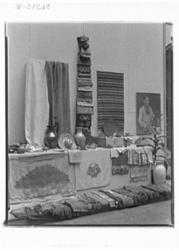 Rural arts exhibition held under the auspices of the Farm Security Administration (FSA) in the patio of the U.S. Department of Agriculture building. Rugs from WPA (Works Progress Administration), Colorado; finger weaving from Vermont and North Carolina; woven towels from Southern Highlands; pottery 