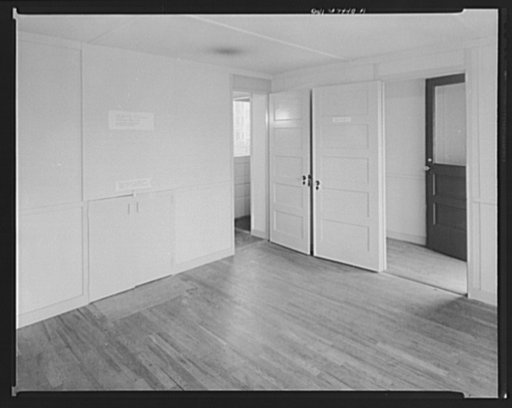 Houses for Britain. Living room looking towards front entrance, and left to kitchen entrance of  prefabricated model house erected by the Federal Public Housing Authority at Scott Circle, Washington, D.C. of the type of temporary, emergency dwelling which it is planned to ship to Great Britain under