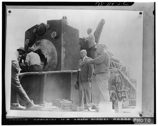 Aberdeen Proving Ground, Maryland. Major General Charles T. Harris, Jr., explaining the workings of the breech in a sixteen-inch gun to Congressman Andrew J. May, chairman of the House Military Affairs Committee. Mr. May saw the huge gun fired, then toured the proving ground, and examined mobile art