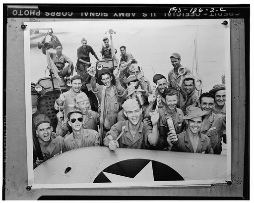 Kelly Field, Texas. Skilled mechanics, these young men are working on a hangar line which is turning out fighting pilots almost as fast as assembly lines can produce the ships for them to fly
