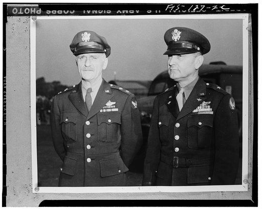 Major General Carl Spaatz, commanding general Air Forces, Etousa, of Earlville, Pennsylvania, and Brigadier General Ira C. Eaker of Lane County, Texas, as they awarded decorations to airmen in Britain