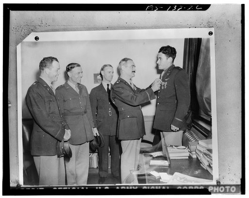 Second Lieutenant Samuel S. Junkin, Jr., U.S. Army Air Force of Natchez, Mississippi, at a Canadian army hospital in Britain. He has been awarded two high United States for bravery: the Distinguished Flying Cross and the Purple Heart. He was decorated by Brigadier General F.O.D. Hunter, Commanding G