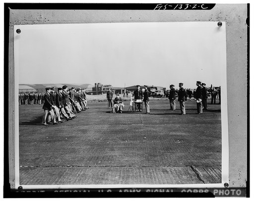 Men marching forward to receive a Distinguished Flying Cross and an order of the Purple Heart from Major General Carl Spaatz, Commanding General of the Air Forces, Etousa, of Earlesville, Pennsylvania