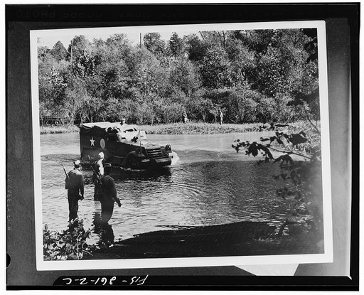 An armored half-track vehicle belonging to a medical unit fording the river during the Second Army's middle Tennessee maneuvers
