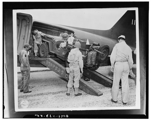 San Antonio, Texas. From a position behind the "front lines", the airborne troopers were rushed to the objective on a split-second schedule to deliver the first blow in a carefully-planned offensive. A jeep is being loaded into a plane as part of this problem