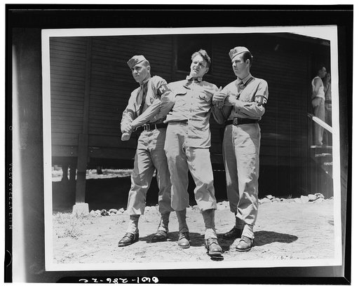 Fort McPherson, Georgia. Left to right: Private First Class Sheldon Ehrlich, Private Edward Tevault, and Private Melvin Kearney practicing a "come along" hold