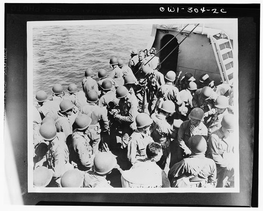 Troops of the Army Task Force, enroute from New Caledonia to the Solomon Islands, checking their rifles and preparing for inspection. They are wearing the new-type U.S. Army helmet