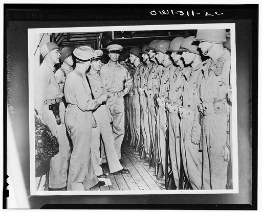 Captain Charles Paul McFeaters, commander of the transport; Rear Admiral Kelly Turner; Vice Admiral Robert Lee Ghormley; Major General M.F. Harmon, commander of the Army forces in the South Pacific area; and Major General Alexander M. Patch. Jr., inspecting the troops of the Army Task Force aboard t