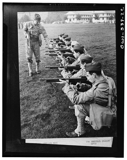 Mitchel Field, New York. Positions with the Thompson machine gun are practiced by members of the air base squadron. This lesson is known as "dry firing." The men get the feel of the gun before they go on the firing line to use real ammunition