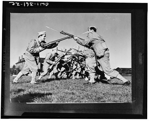 Mitchel Field, New York. Air Corps technicians must be expert in the handling of infantry weapons. Members of an airbase squadron learning to wage hand-to-hand combat with bayonets under the tutelage of Captain Clifford W. Vedder, squadron commander
