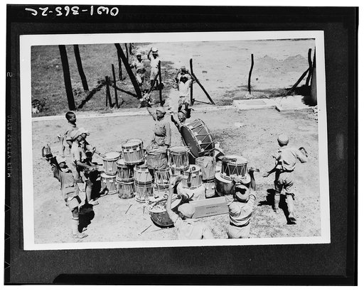 Chinese soldiers of the United Nations forces in India register their pleasure upon receiving a shipment of regimental drums and bugles