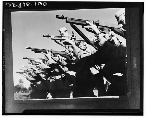 Mitchel Field, New York. On the rifle range members of the airbase squadron learn to fire the snubnose Thompson sub-machine gun. The highest degree of proficiency in the use of these firearms is attained in the intensive training program