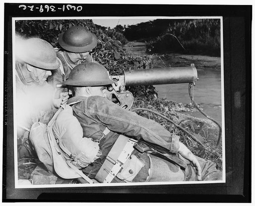 A machine gun crew of American troops in the British West Indies guarding a strategic point along a river during the course of maneuvers