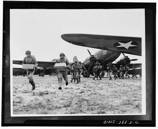 Landing operation of U.S. Airborne Infantry force somewhere in the southwestern United States. Troops unloading supplies and ammunition from transport planes