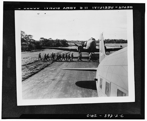 U.S. paratroopers preparing to board planes during manuevers somewhere in England