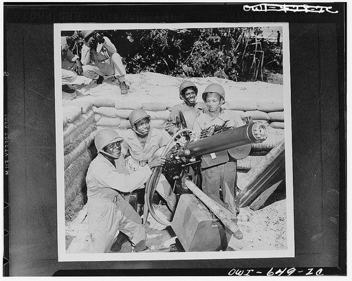 Troops at a U.S. Army airbase in New Hebrides manning a heavy machine gun. Left to right: Private First Class Elliott Moore, Trenton, New Jersey; Corporal Raymond Elliott, Jaspar, Alabama; Corporal Johnny Jackson, Augusta, Georgia; Private First Class Shade Mackee, Jr., Ashland, Alabama