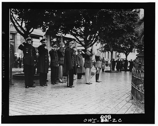 French and American officers saluting during flag raising ceremonies somewhere in North Africa. First row, right to left: the French General Boiseau; American Major General Lloyd R. Fredendhall; third party unidentified