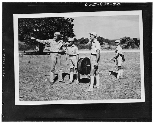 Chinese troops receiving instructions in the laying of wire from Corporal Eyen Huey, United States Army instructor