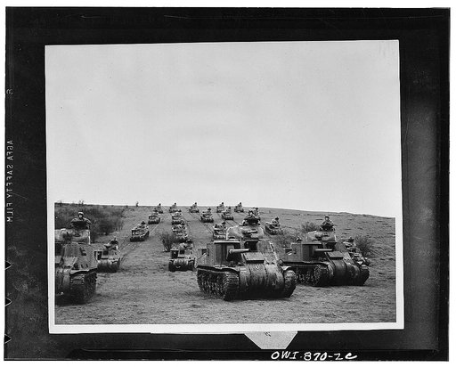 American tanks thunder down an English plain during group maneuvers. These are the modern juggernauts that are rolling up United Nations victories in the European theater