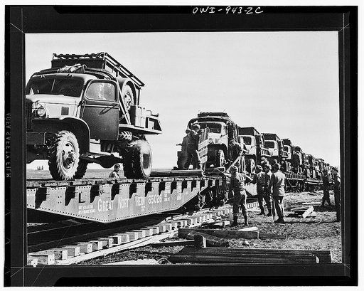 Bringing in trucks and supplies by flatcar for building the Alcan Highway