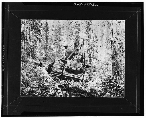 Caterpillar tractor cutting a road through the forest for the Alcan Highway