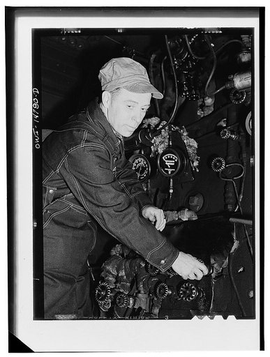 Hammond, Illinois. Switchman riding a car in an Illinois Central Railroad classification yard