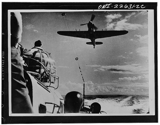 Operations in North Africa by Allied air forces. A Royal Air Force high speed launch being directed by a low-flying Hurricane to the spot where a United States pilot is down off the North African Coast
