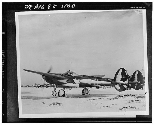 United States Army Air Forces P-38 being warmed up in a snow swept air field somewhere in Iceland