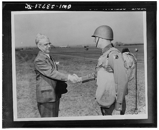 His Excellency Cimon P. Diamattoupoulos congratulates Brigadier General Louis J. Portier (Division Artillery Commander, 94th Infantry division) after presenting the Order of George I to him