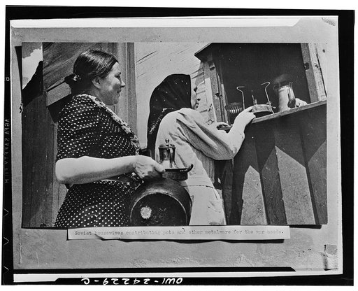 Housewives collecting thir pots and other metal ware to be turned in for scrap in the USSR (Union of Soviet Socialist Republics)