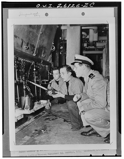 Sheepshead Bay, Brooklyn, New York. Burner assembly by two members of an engineering class at the United States Maritime Service training dtation. Lieutenant L.M. Breece, USNR, is the instructor