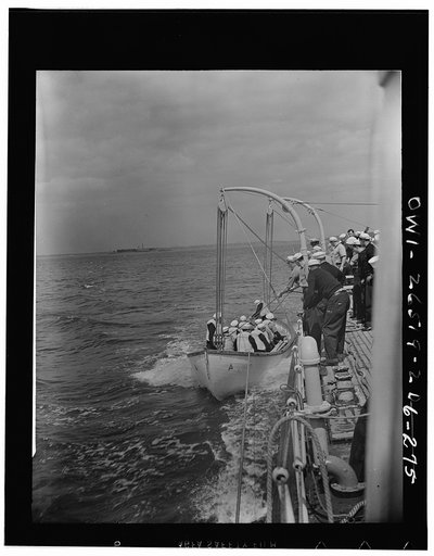 Trainees in the United States Maritime Service launching a lifeboat
