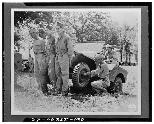 Manchester (vicinity), Tennessee. Soldiers of headquarters company of the Armored Corps lifting a jeep to repair it at their bivouac area during Second Army maneuvers. Left to right: Private William Lowe, Captain Frank Yung, Private Sam Salen, and Private J.J. Nay