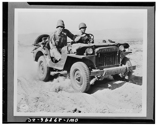 Indio, California. A half-ton jeep rolling over the desert at the desert training center