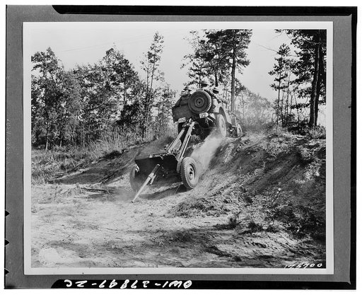 Wadesboro, North Carolina. Jeep on maneuvers crossing rough terrain pulling a thirty-seven millimeter anti-tank gun. Battery D of the Fourty-four Division Anti-tank, Second Corps