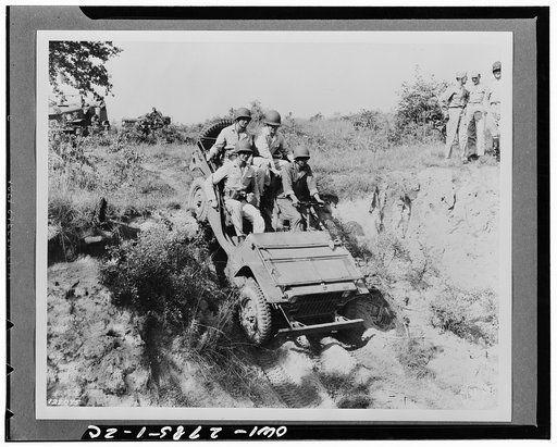 Fort Benning, Georgia. West Point cadets and a soldier driving a jeep