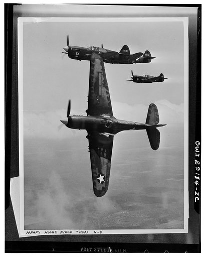 Moore Field, Mission (vicinity), Texas. The lead ship in a formation of P-40's peeling off for the "attack" in a practice flight at the Army Air Forces advanced flying school. Selected aviation cadets are given transition training in these fighter planes before receiving their pilot's wings