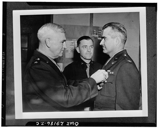 Colonel Benjamin B. Talley, engineering officer who planned and supervised the construction of all army installations in Alaska, receiving the Distinguished Service Medal from Major-General Simon Bolivar Buckner, Jr., commanding general of the Alaska Defense Command at his headquarters in Alaska