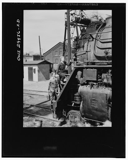 Clinton, Iowa. Women wipers of the Chicago and Northwestern railroad cleaning one of the giant locomotives