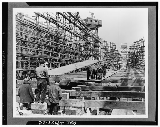 Bethlehem Fairfield shipyards, near Baltimore, Maryland. Construction of a Liberty ship. On the second day all horizintal beams have been laid and keel blocks set at the proper pitch. Keel plates are being put in place