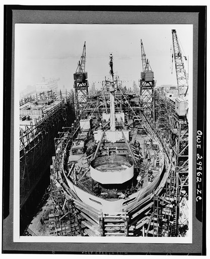 Bethlehem Fairfield shipyards, near Baltimore, Maryland. Construction of a Liberty ship. With two days to go before launching, all structural work is being completed. Underwater installations are in place and the hull has been painted