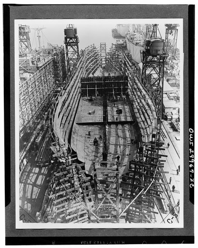 Bethlehem Fairfield shipyards, near Baltimore, Maryland. Construction of a Liberty ship. On the third day the bottom is completed except for forward and aft ends, and on it have been set inner bottom tanks for fuel or ballast. The midships bulkhead has been raised