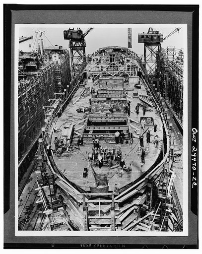 Bethlehem Fairfield shipyards, near Baltimore, Maryland. Construction of a Liberty ship. On the fourteenth day the upper deck has been erected and mast houses and the after-deck house are in place. Electrical conduits and engine and boiler room piping are being installed