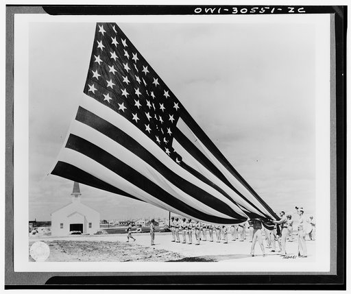Soldier unfolding Garrison flags at Fort Hood, Texas